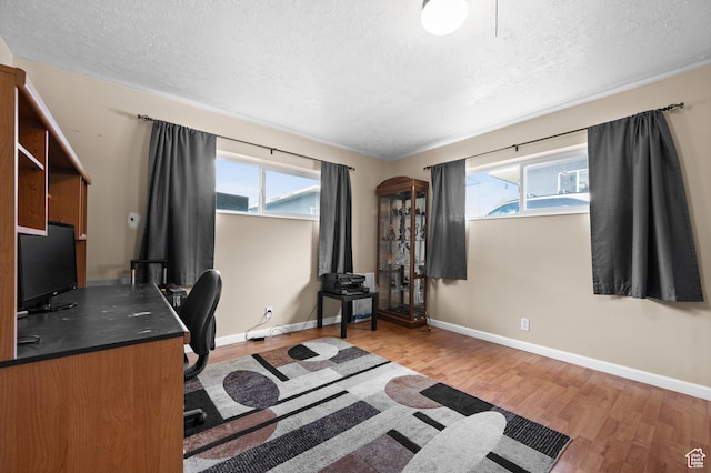 4314 S 615 E, Millcreek, UT 84107 - office area featuring a textured ceiling, wood finished floors, plenty of natural light, and baseboards