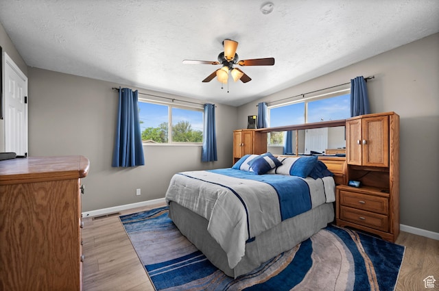 4314 S 615 E, Millcreek, UT 84107 - bedroom with baseboards, light wood-style floors, ceiling fan, and a textured ceiling