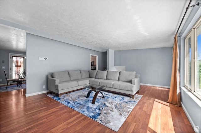 4314 S 615 E, Millcreek, UT 84107 - living room featuring wood finished floors, baseboards, and a textured ceiling