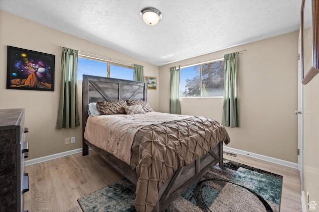 4314 S 615 E, Millcreek, UT 84107 - bedroom with a textured ceiling, baseboards, light wood-style floors, and vaulted ceiling