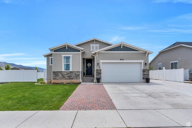 1460 E Lowe Peak Dr, Eagle Mountain, UT 84005 - craftsman house featuring driveway, stone siding, an attached garage, and stucco siding