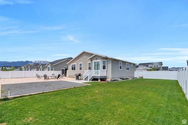 1460 E Lowe Peak Dr, Eagle Mountain, UT 84005 - back of property featuring a patio and a residential view