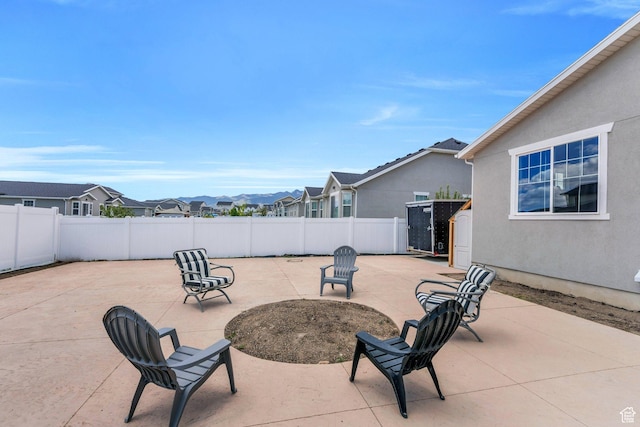 1460 E Lowe Peak Dr, Eagle Mountain, UT 84005 - fenced backyard with a patio and a residential view