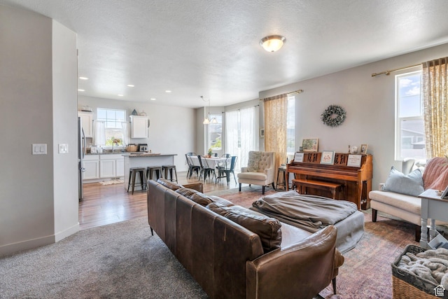 1460 E Lowe Peak Dr, Eagle Mountain, UT 84005 - living area featuring carpet, baseboards, and recessed lighting