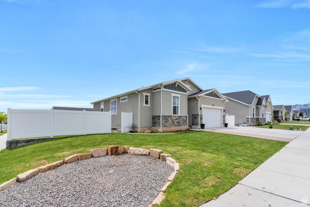 1460 E Lowe Peak Dr, Eagle Mountain, UT 84005 - craftsman inspired home featuring concrete driveway, stucco siding, a garage, a residential view, and stone siding