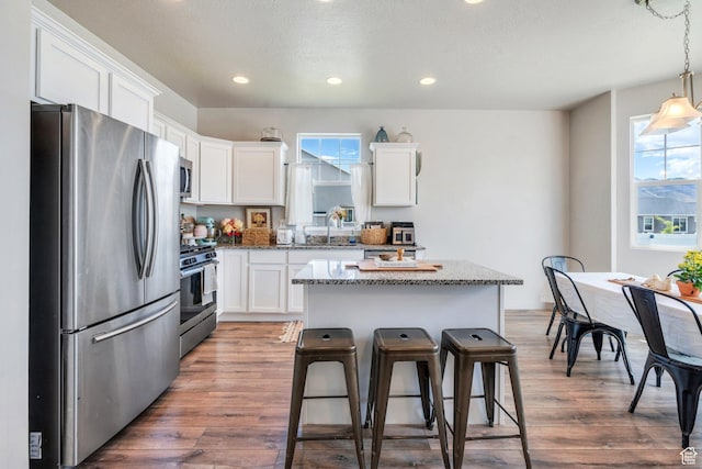 1460 E Lowe Peak Dr, Eagle Mountain, UT 84005 - kitchen with stainless steel appliances, white cabinetry, healthy amount of natural light, recessed lighting, and a textured ceiling