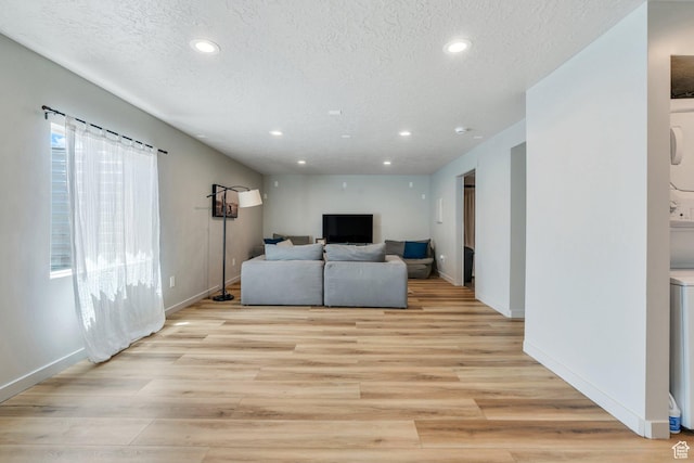 1460 E Lowe Peak Dr, Eagle Mountain, UT 84005 - living room with recessed lighting, a textured ceiling, baseboards, and light wood-type flooring