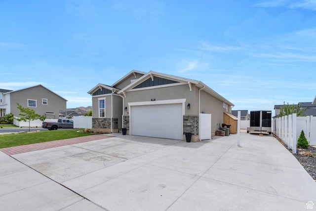 1460 E Lowe Peak Dr, Eagle Mountain, UT 84005 - craftsman-style home with driveway, stone siding, stucco siding, and a garage