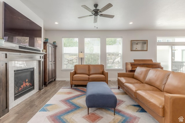 242 E Ridgeline Way N, Salt Lake, UT 84054 - living area with a ceiling fan, a tiled fireplace, light wood-style flooring, recessed lighting, and baseboards
