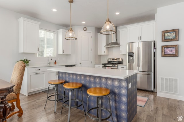 242 E Ridgeline Way N, Salt Lake, UT 84054 - kitchen featuring stainless steel appliances, a sink, light countertops, wood finished floors, and recessed lighting
