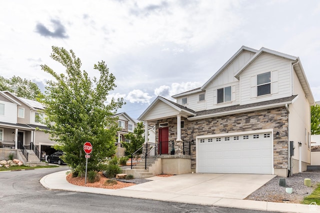242 E Ridgeline Way N, Salt Lake, UT 84054 - view of front facade with a garage, concrete driveway, stone siding, and board and batten siding