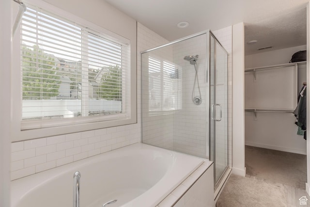 242 E Ridgeline Way N, Salt Lake, UT 84054 - bathroom with a shower stall, a bath, a spacious closet, and baseboards