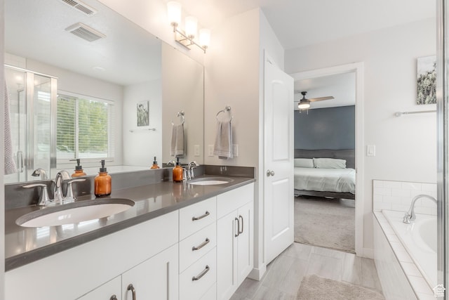242 E Ridgeline Way N, Salt Lake, UT 84054 - bathroom featuring ensuite bath, ceiling fan, a relaxing tiled tub, double vanity, and a shower with shower door