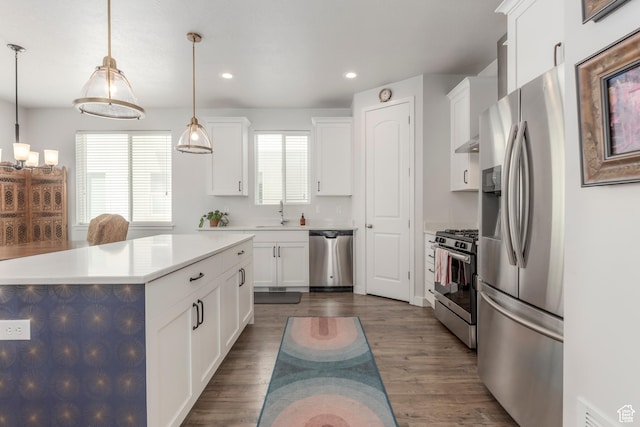 242 E Ridgeline Way N, Salt Lake, UT 84054 - kitchen featuring appliances with stainless steel finishes, white cabinets, a sink, recessed lighting, and hanging light fixtures
