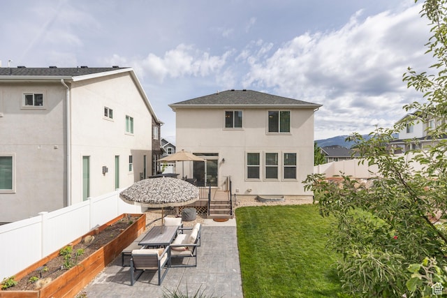242 E Ridgeline Way N, Salt Lake, UT 84054 - back of property featuring a vegetable garden, stucco siding, and a patio area