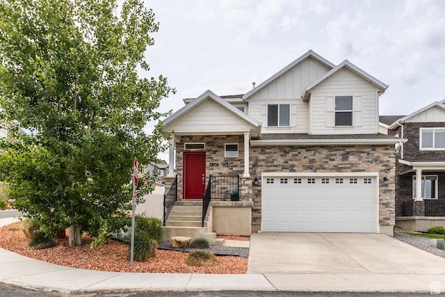 242 E Ridgeline Way N, Salt Lake, UT 84054 - craftsman-style house with board and batten siding, an attached garage, concrete driveway, and stone siding