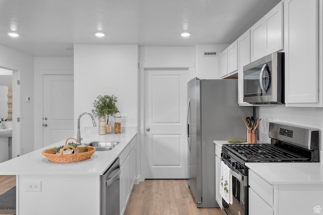 1261 N 375 E Unit 155, Harrisville, UT 84404 - kitchen with stainless steel appliances, a sink, a peninsula, light wood-style floors, and light countertops