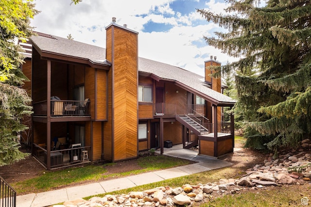 2025 S Canyon Resort Dr Unit F-8, Park City, UT 84098 - rear view of house with a chimney, roof with shingles, a balcony, and stairs