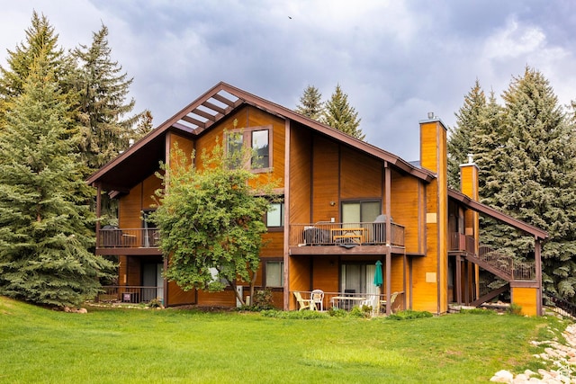 2025 S Canyon Resort Dr Unit F-8, Park City, UT 84098 - rear view of house featuring a chimney, a yard, and a balcony