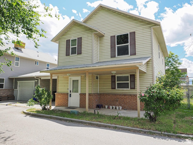 787 W Lennox St S, Midvale, UT 84047 - view of front of property with brick siding, an attached garage, and covered porch
