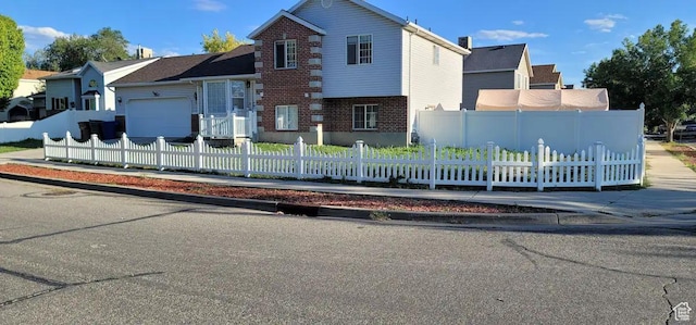 1004 N Sir Michael Dr, Salt Lake City, UT 84116 - traditional-style house with a garage, brick siding, and a fenced front yard
