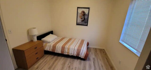 1004 N Sir Michael Dr, Salt Lake City, UT 84116 - bedroom with light wood-style flooring and baseboards