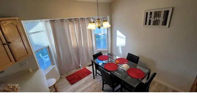 1004 N Sir Michael Dr, Salt Lake City, UT 84116 - dining area featuring a chandelier, light wood-style floors, and baseboards