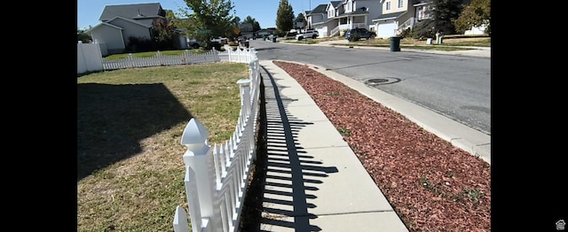 1004 N Sir Michael Dr, Salt Lake City, UT 84116 - view of asphalt road with sidewalks, a residential view, and curbs