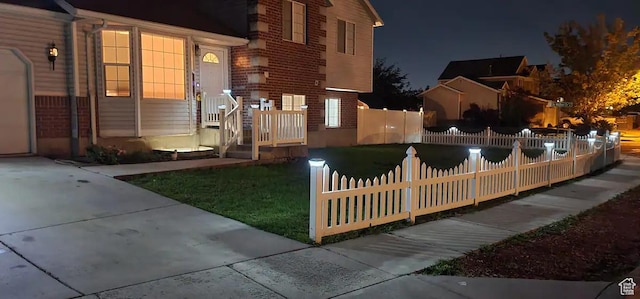 1004 N Sir Michael Dr, Salt Lake City, UT 84116 - exterior space with a fenced front yard and brick siding