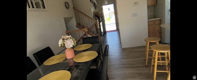 1004 N Sir Michael Dr, Salt Lake City, UT 84116 - dining room featuring stairs, wood finished floors, and baseboards