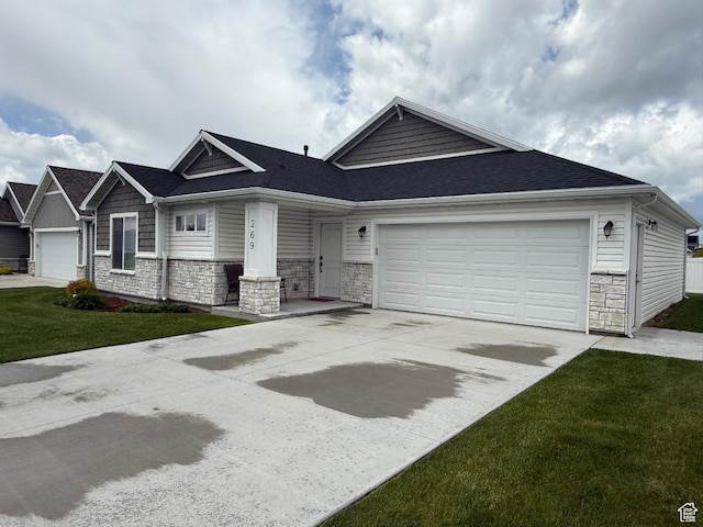 269 W 520 S, Hyde Park, UT 84318 - view of front of property with stone siding, a garage, driveway, a front yard, and a shingled roof