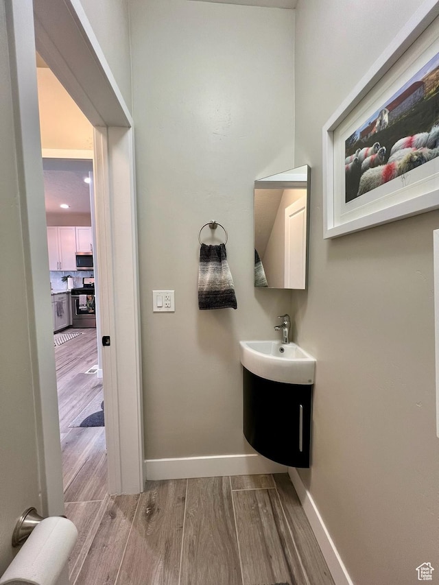 15456 S Navy Trails Ln W, Bluffdale, UT 84065 - bathroom featuring wood finished floors, baseboards, and vanity