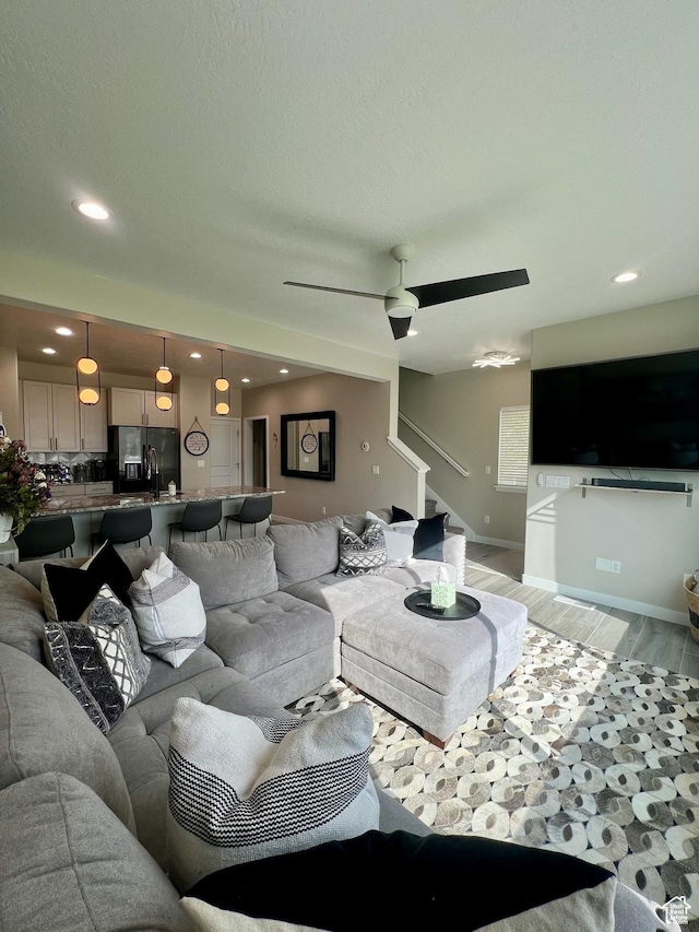 15456 S Navy Trails Ln W, Bluffdale, UT 84065 - living area featuring stairs, light wood-style floors, recessed lighting, ceiling fan, and baseboards