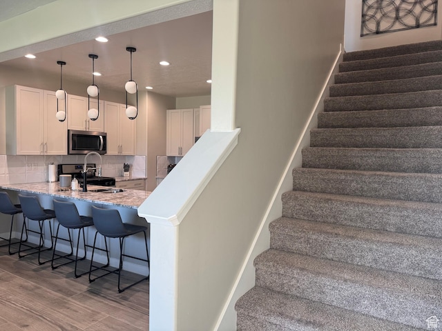 15456 S Navy Trails Ln W, Bluffdale, UT 84065 - stairway with wood finished floors and recessed lighting
