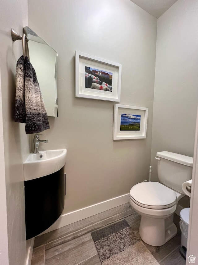 15456 S Navy Trails Ln W, Bluffdale, UT 84065 - bathroom featuring wood finished floors, toilet, baseboards, and vanity