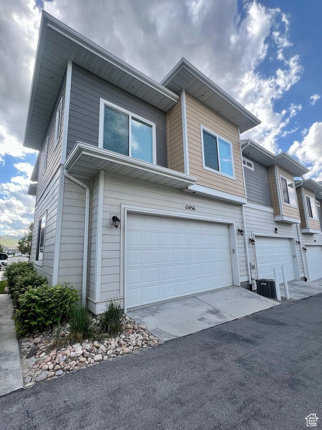 15456 S Navy Trails Ln W, Bluffdale, UT 84065 - view of front of home with an attached garage, cooling unit, and driveway