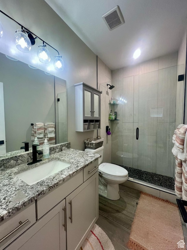 15456 S Navy Trails Ln W, Bluffdale, UT 84065 - full bathroom featuring wood finished floors, a stall shower, toilet, and vanity