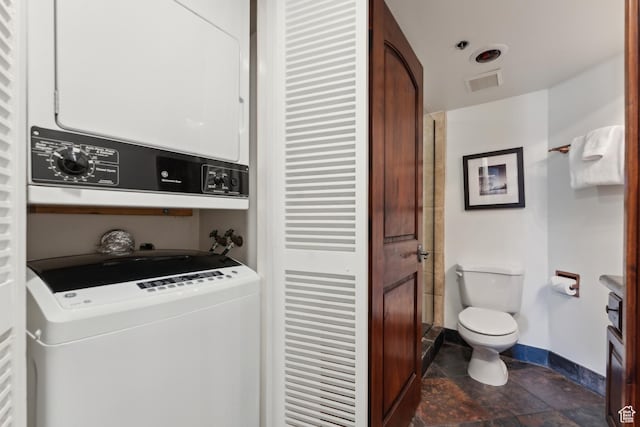 1485 Empire Ave Unit 201, Park City, UT 84060 - laundry room with stacked washer / drying machine, baseboards, and dark stone finish flooring
