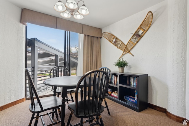1485 Empire Ave Unit 201, Park City, UT 84060 - dining room with a textured wall, carpet, a chandelier, and baseboards