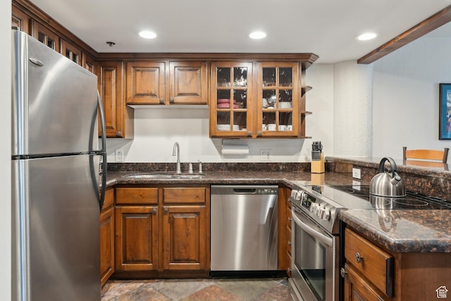 1485 Empire Ave Unit 201, Park City, UT 84060 - kitchen with appliances with stainless steel finishes, a sink, glass insert cabinets, brown cabinetry, and recessed lighting