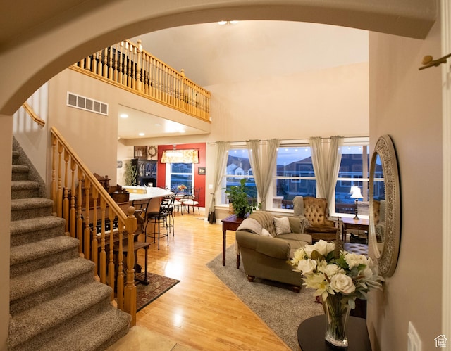 954 E 960 S, Ephraim, UT 84627 - living room featuring a high ceiling, stairway, wood finished floors, and arched walkways