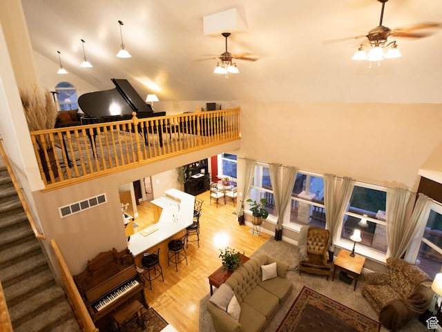 954 E 960 S, Ephraim, UT 84627 - living room featuring a ceiling fan, wood finished floors, high vaulted ceiling, and stairs