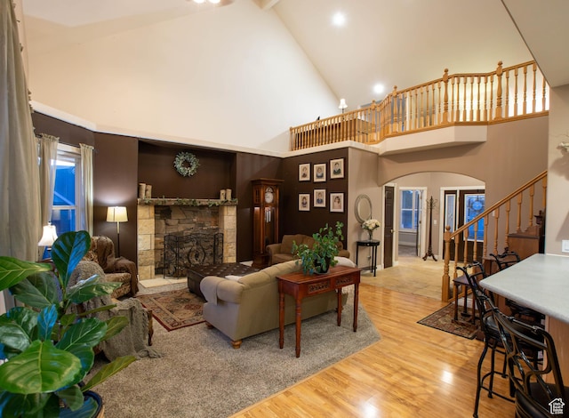 954 E 960 S, Ephraim, UT 84627 - living area with arched walkways, stairs, a stone fireplace, wood finished floors, and high vaulted ceiling