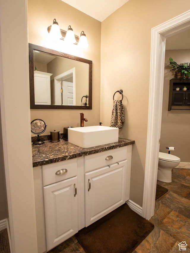954 E 960 S, Ephraim, UT 84627 - bathroom with baseboards, stone finish floors, vanity, and toilet