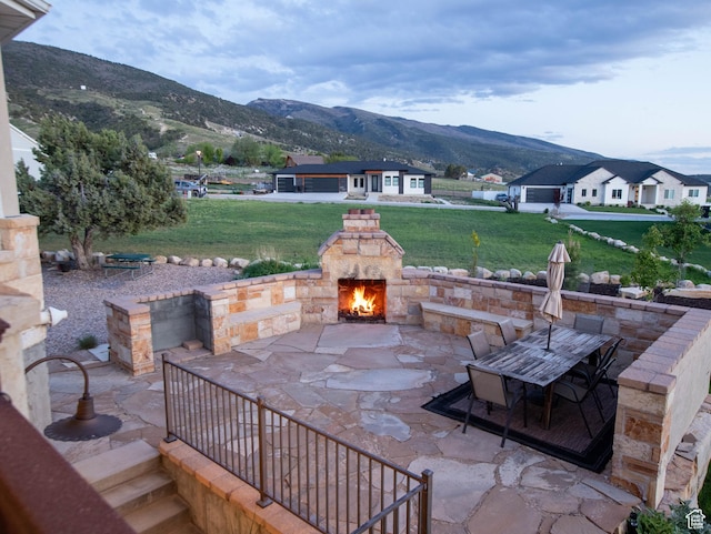 954 E 960 S, Ephraim, UT 84627 - view of patio / terrace featuring a mountain view, an outdoor stone fireplace, and outdoor dining space