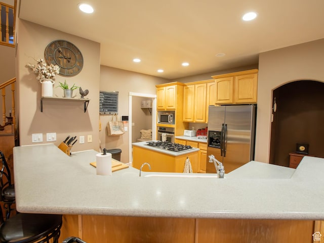 954 E 960 S, Ephraim, UT 84627 - kitchen with appliances with stainless steel finishes, light brown cabinetry, a peninsula, recessed lighting, and a kitchen breakfast bar