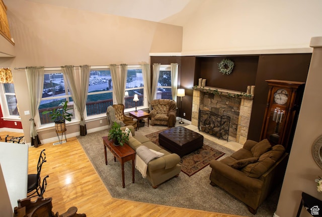 954 E 960 S, Ephraim, UT 84627 - living area with wood finished floors, a stone fireplace, high vaulted ceiling, and baseboards