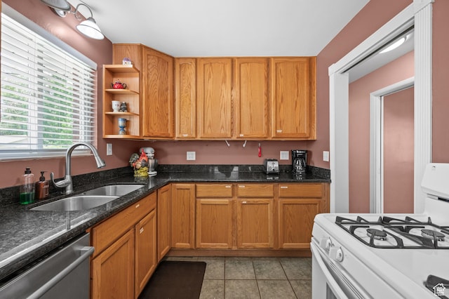 475 E 6815 S, Midvale, UT 84047 - kitchen with gas range gas stove, stainless steel dishwasher, a sink, light tile patterned floors, and dark stone counters
