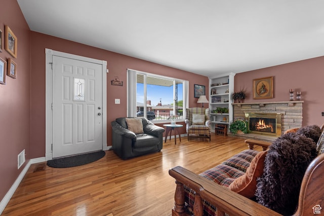 475 E 6815 S, Midvale, UT 84047 - living area with light wood-style flooring, a stone fireplace, and baseboards