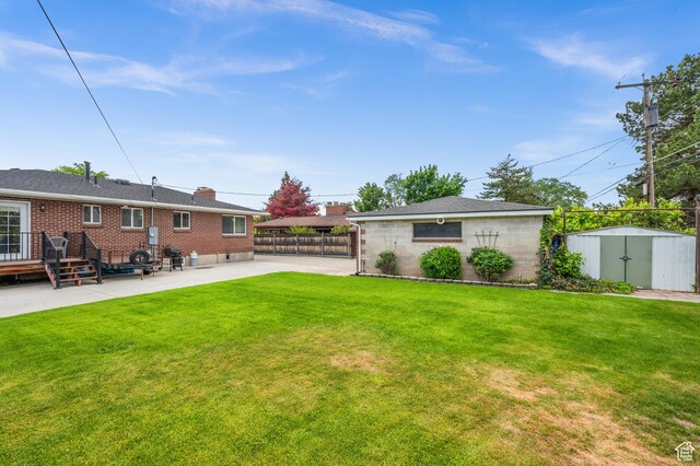 475 E 6815 S, Midvale, UT 84047 - back of house with a patio, brick siding, and a chimney